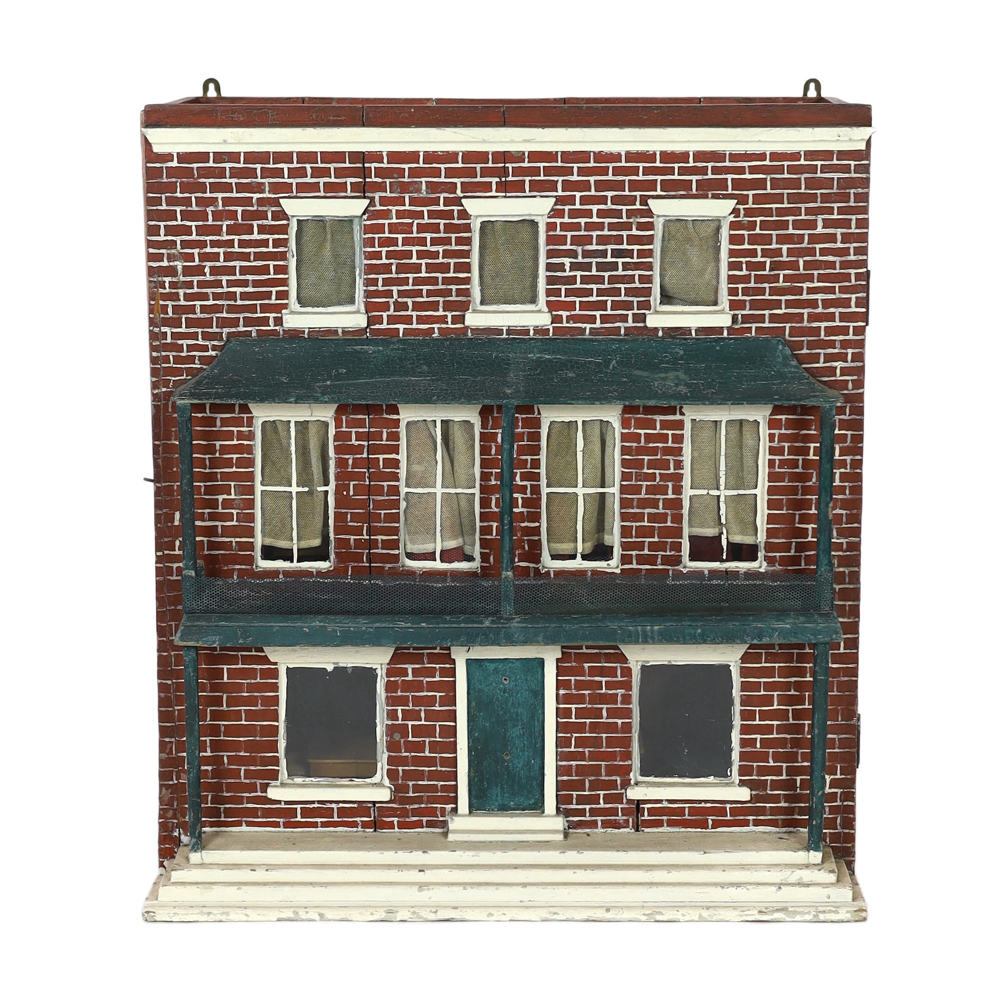 A Victorian furnished dolls’ house, circa 1890, 77cm high.